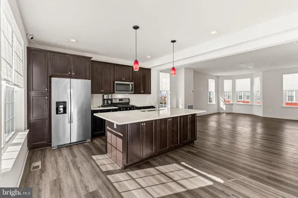 a kitchen with stainless steel appliances granite countertop a stove and cabinets