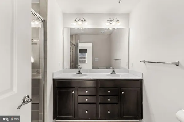 a bathroom with a glass shower door