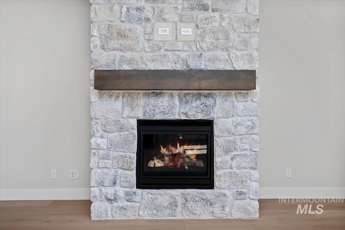 232 South Fusion Avenue Kuna, ID 83634 - Photo 22 of 50 Detailed view of a glass covered fireplace and wood finished floors