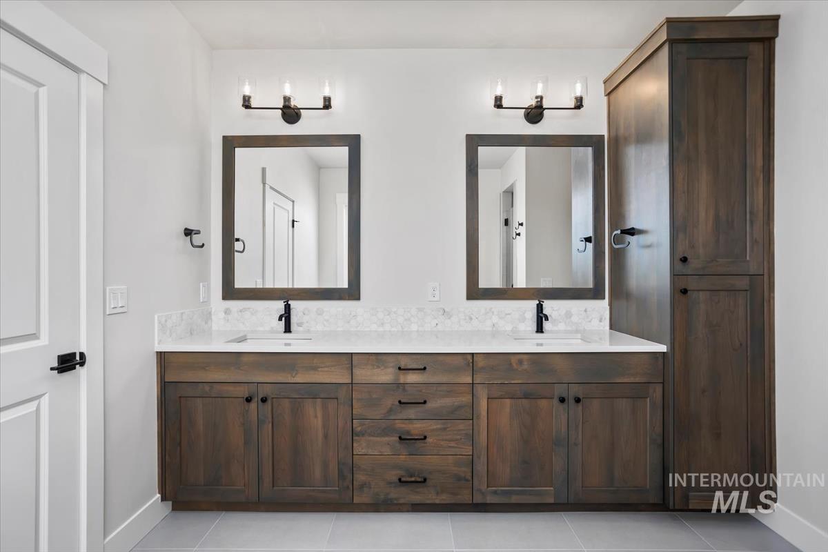 232 South Fusion Avenue Kuna, ID 83634 - Photo 25 of 50 Bathroom with double vanity and light tile patterned floors