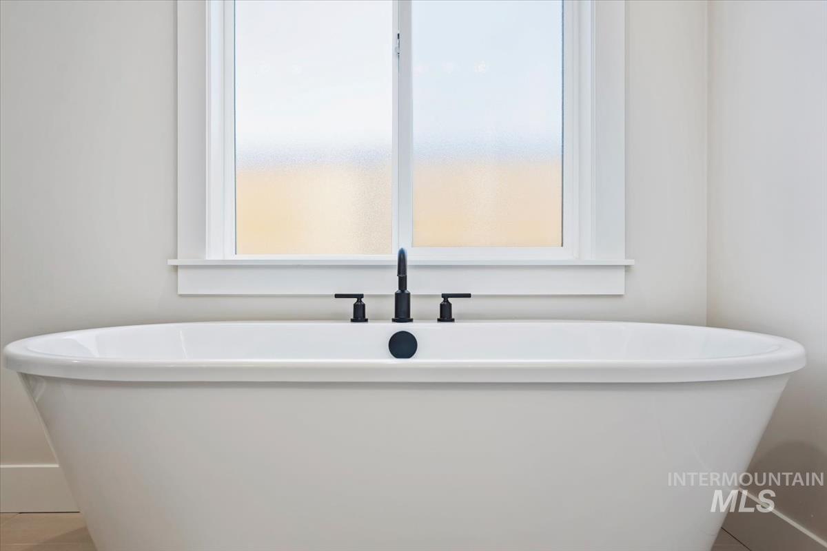 232 South Fusion Avenue Kuna, ID 83634 - Photo 28 of 50 Bathroom featuring a soaking tub and tile patterned flooring