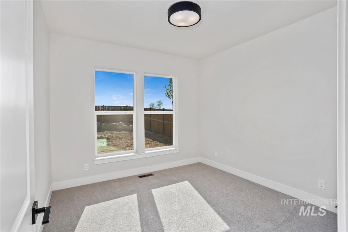 232 South Fusion Avenue Kuna, ID 83634 - Photo 39 of 50 Spare room with light colored carpet and baseboards