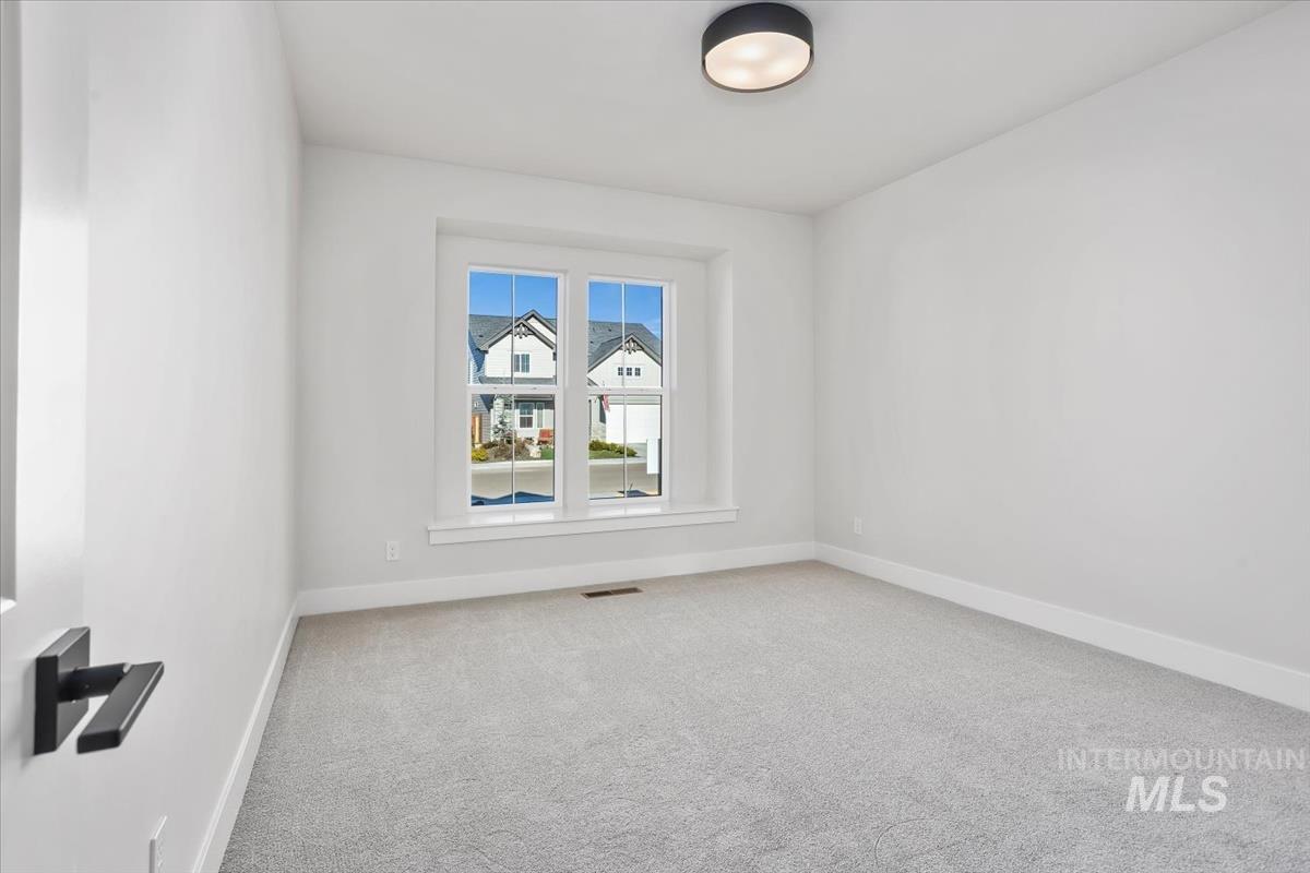 232 South Fusion Avenue Kuna, ID 83634 - Photo 40 of 50 Empty room featuring light carpet and baseboards