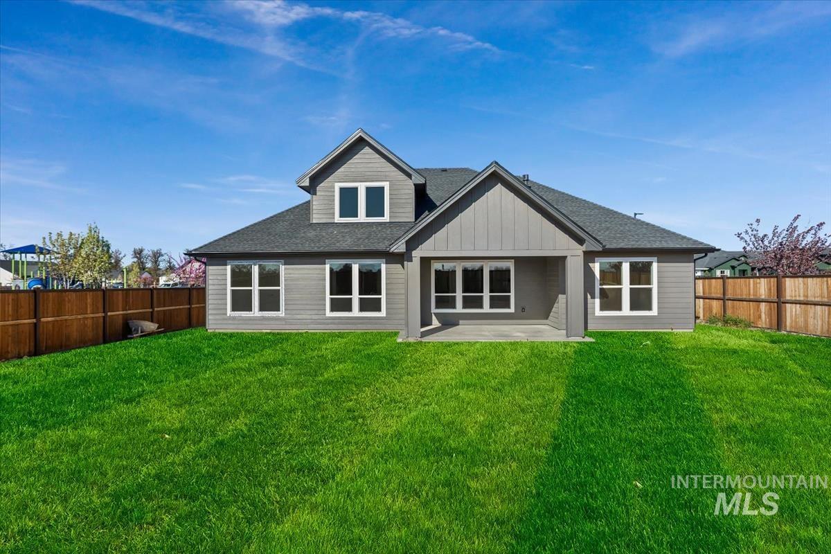 232 South Fusion Avenue Kuna, ID 83634 - Photo 45 of 50 Rear view of property featuring a patio area, a shingled roof, a fenced backyard, and board and batten siding