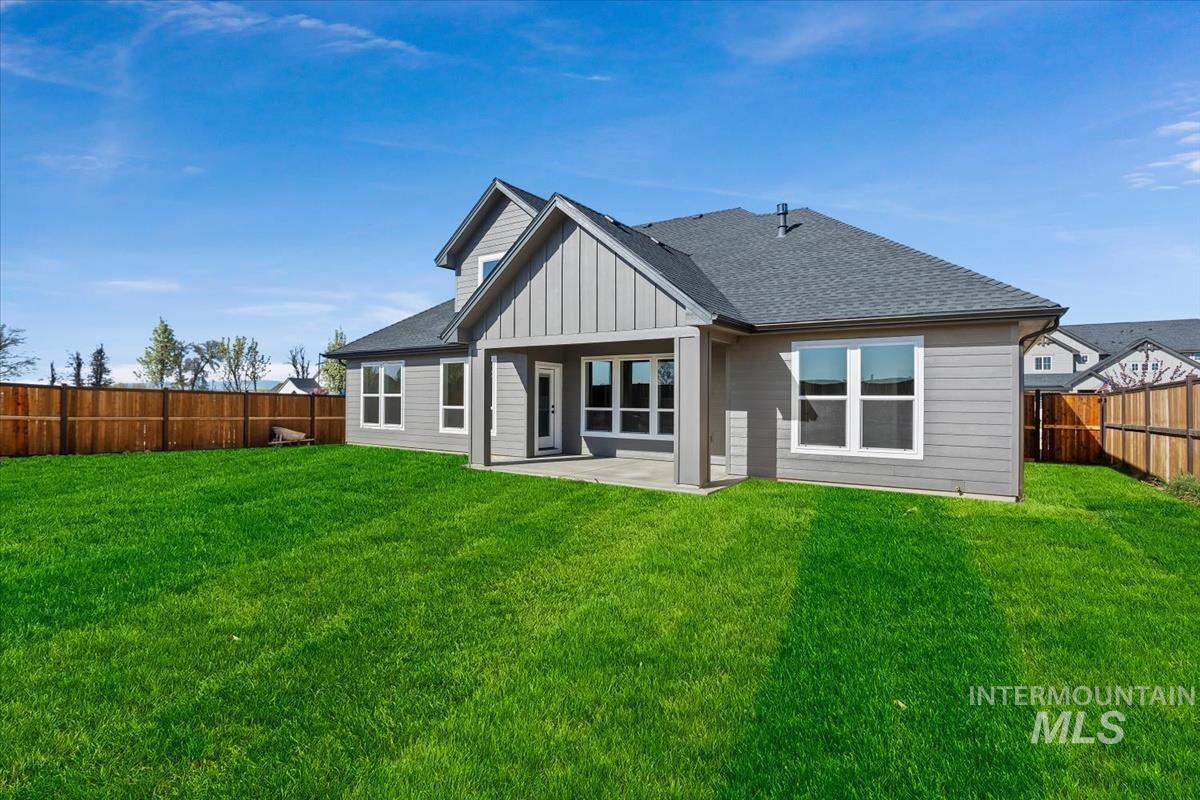 232 South Fusion Avenue Kuna, ID 83634 - Photo 46 of 50 Rear view of property featuring a patio area, a shingled roof, board and batten siding, and a fenced backyard