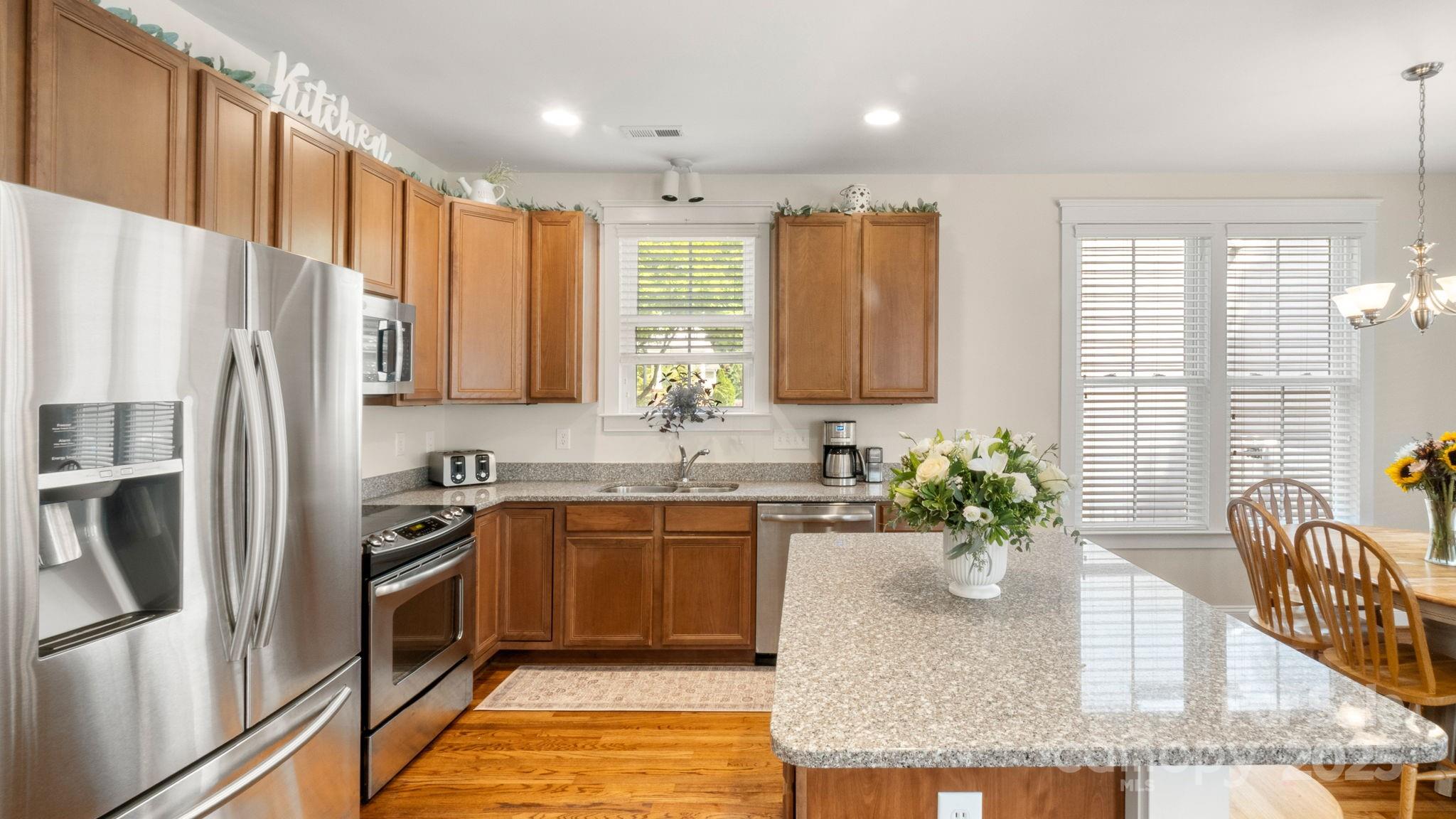 3499 Richard's Crossing Fort Mill, SC 29708 - Photo 12 of 33 a kitchen with stainless steel appliances granite countertop a sink a stove a refrigerator and cabinets