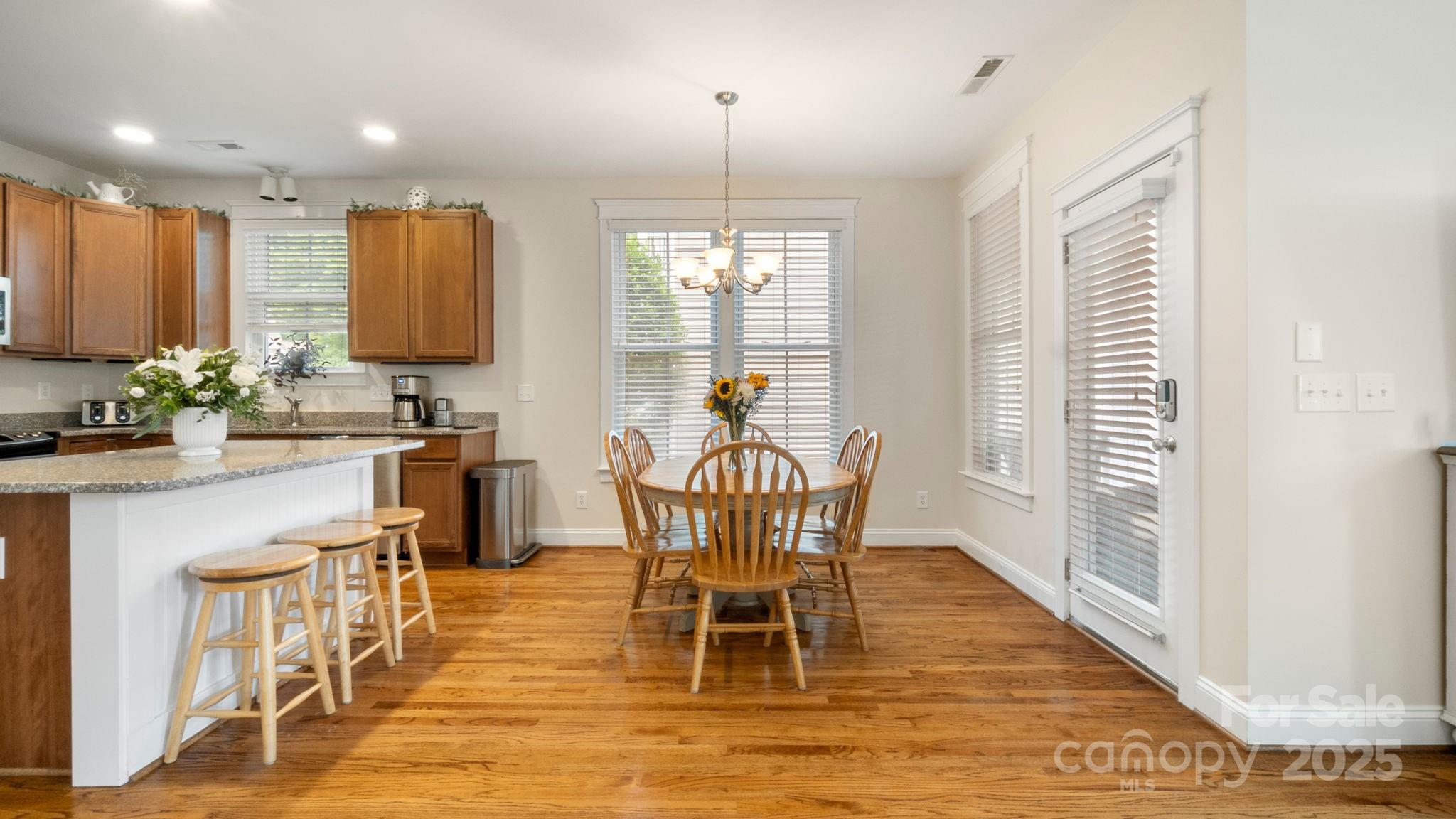 3499 Richard's Crossing Fort Mill, SC 29708 - Photo 14 of 33 a dining room with furniture a chandelier and wooden floor