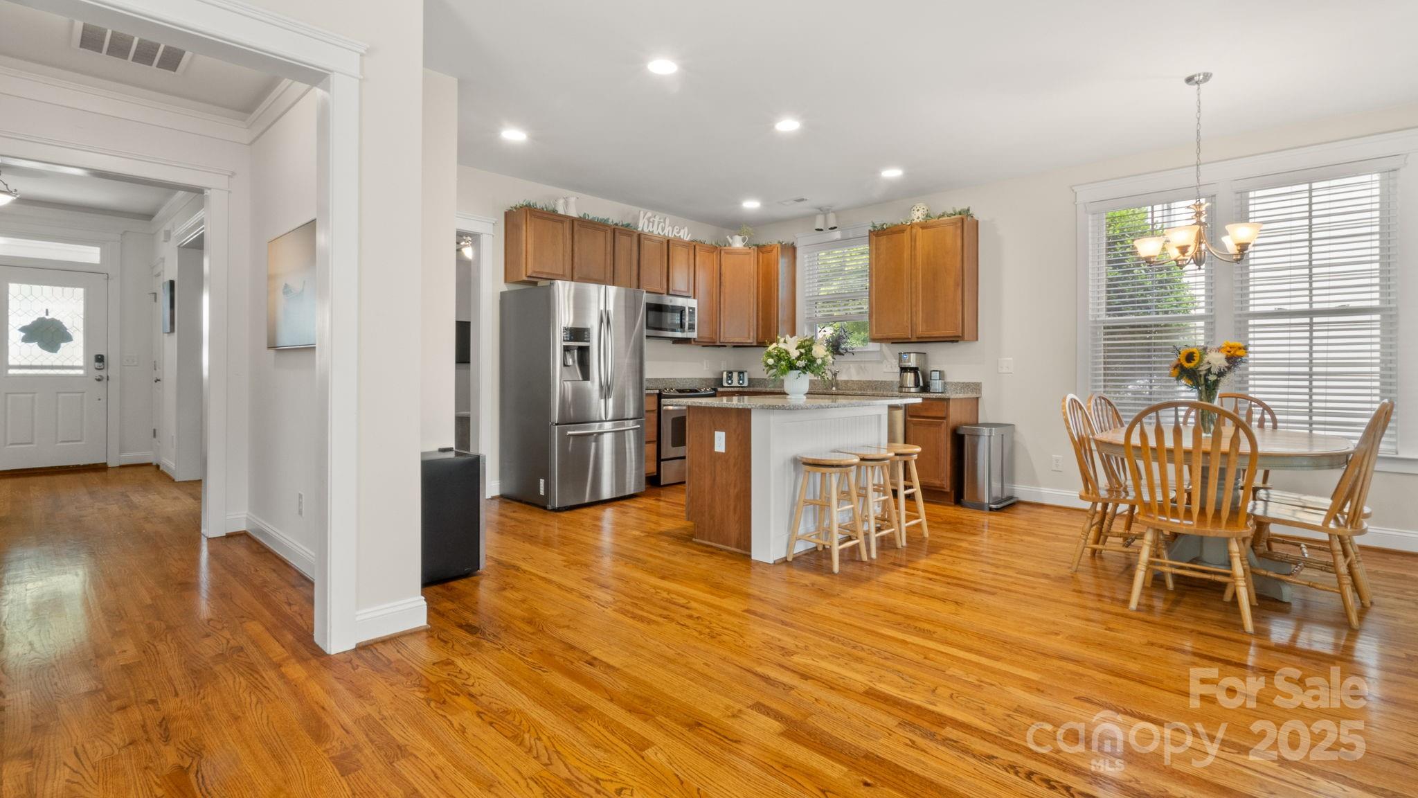 3499 Richard's Crossing Fort Mill, SC 29708 - Photo 17 of 33 a kitchen with stainless steel appliances a dining table chairs stove refrigerator and cabinets