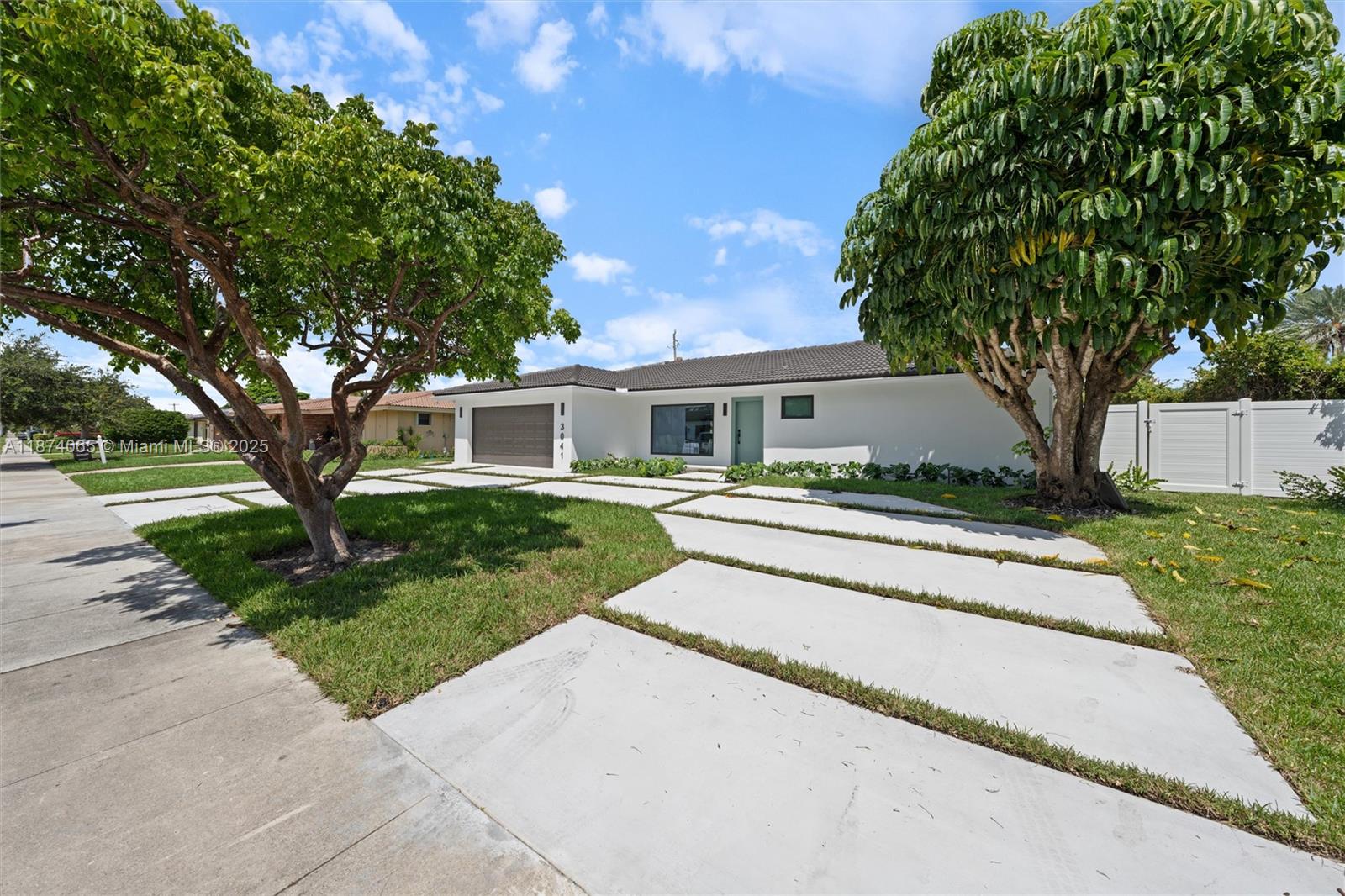 3041 Northeast 45th Street Lighthouse Point, FL 33064 - Photo 1 of 20 front view of a house with a yard