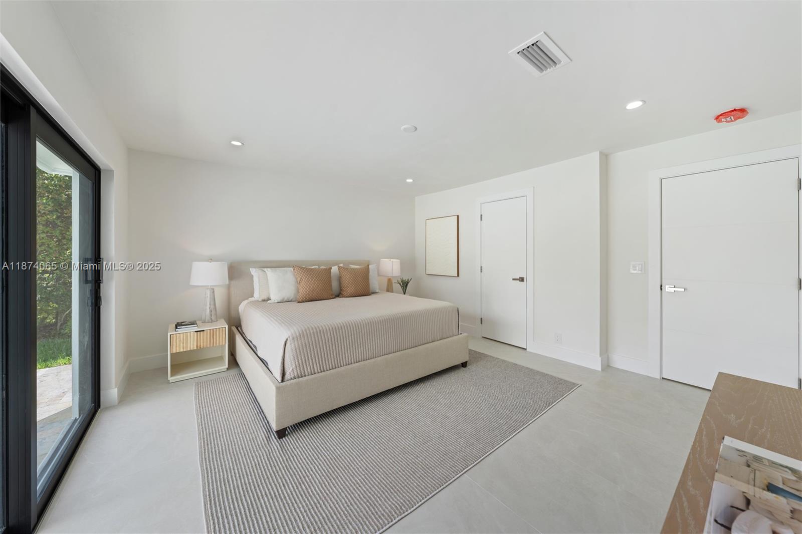 3041 Northeast 45th Street Lighthouse Point, FL 33064 - Photo 11 of 20 a bedroom with a bed and large mirror