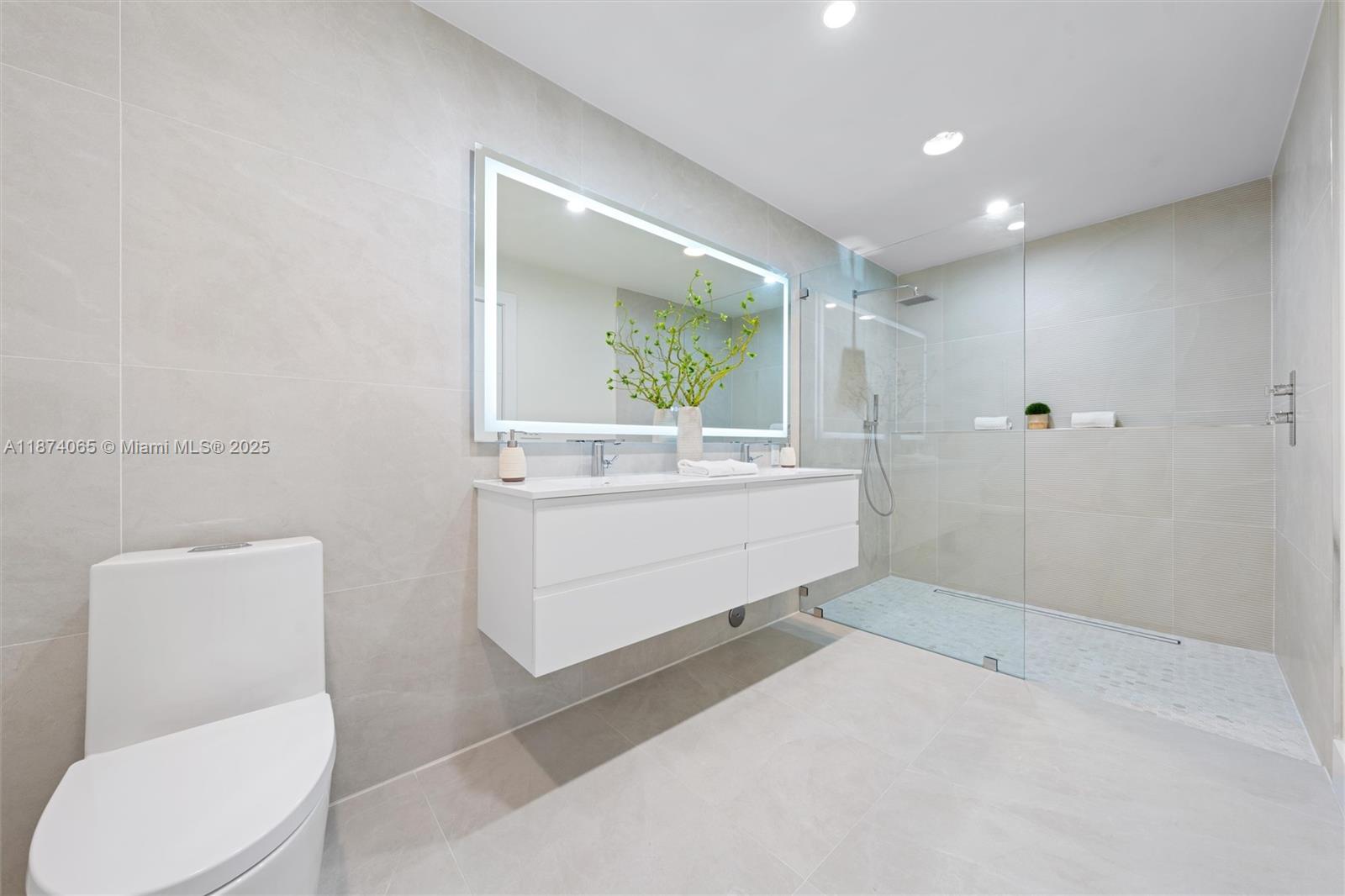 3041 Northeast 45th Street Lighthouse Point, FL 33064 - Photo 13 of 20 a bathroom with a sink toilet and mirror