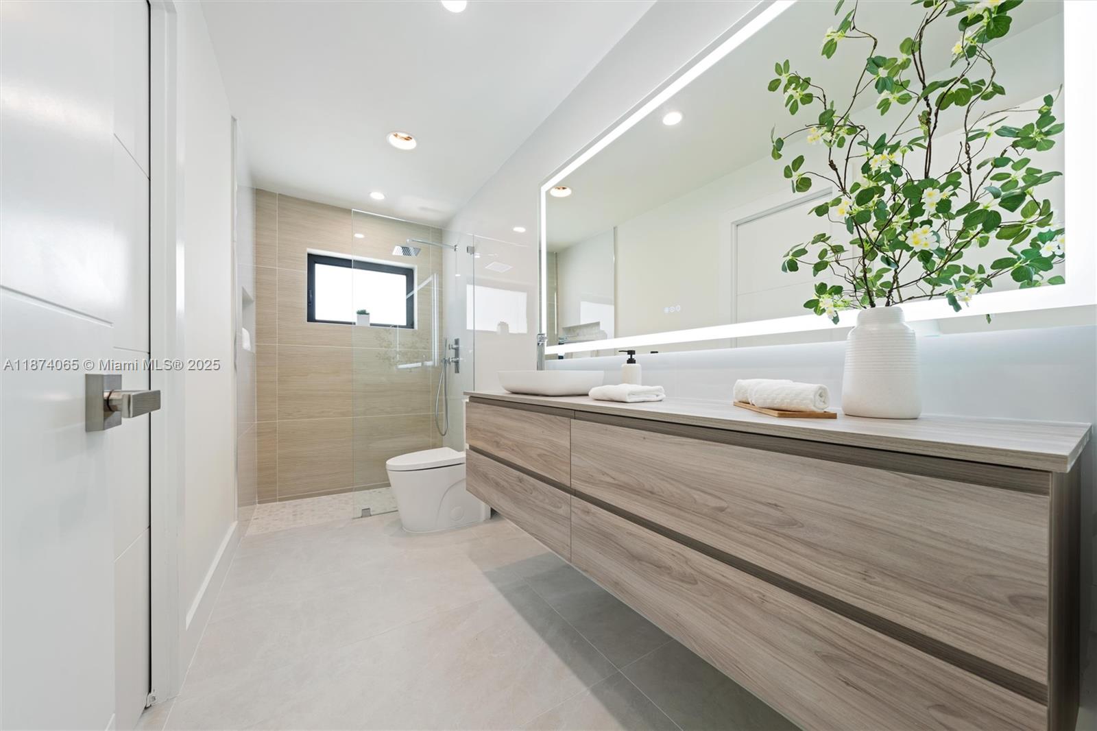 3041 Northeast 45th Street Lighthouse Point, FL 33064 - Photo 15 of 20 a bathroom with a sink a toilet and a shower
