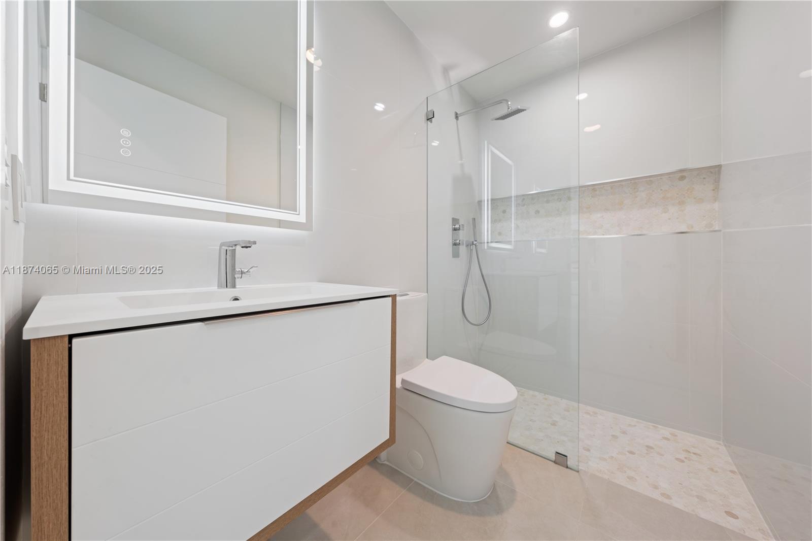 3041 Northeast 45th Street Lighthouse Point, FL 33064 - Photo 17 of 20 a bathroom with a sink toilet and shower