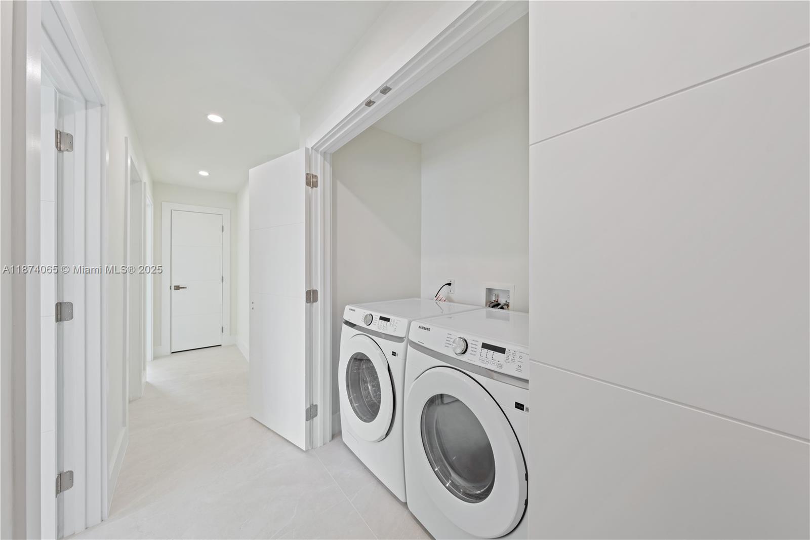 3041 Northeast 45th Street Lighthouse Point, FL 33064 - Photo 18 of 20 a view of storage and utility room with washer and dryer