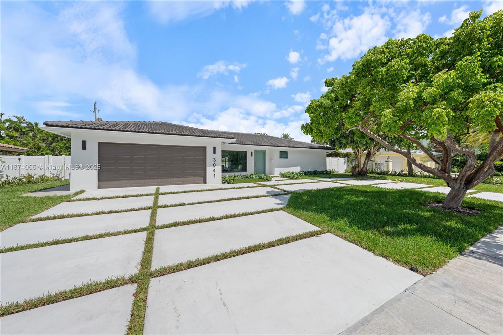 3041 Northeast 45th Street Lighthouse Point, FL 33064 - Photo 2 of 20 front view of house with a yard