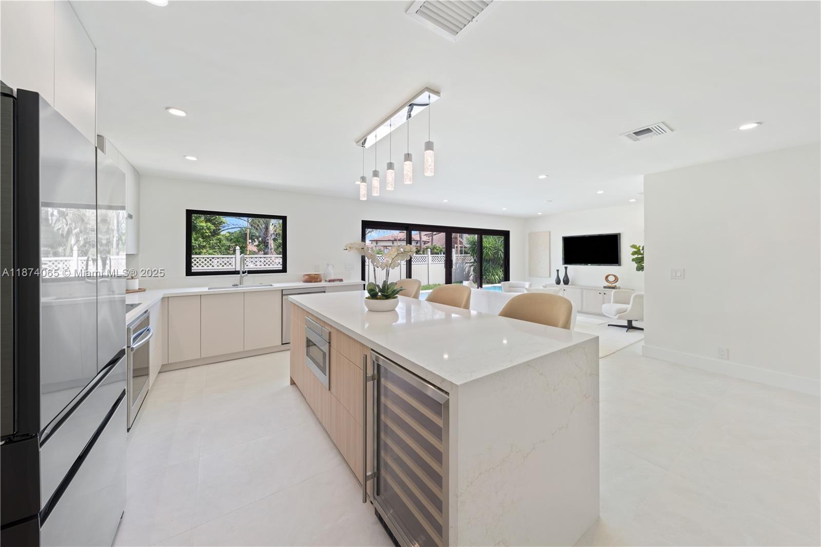 3041 Northeast 45th Street Lighthouse Point, FL 33064 - Photo 6 of 20 a large white kitchen with a sink and refrigerator