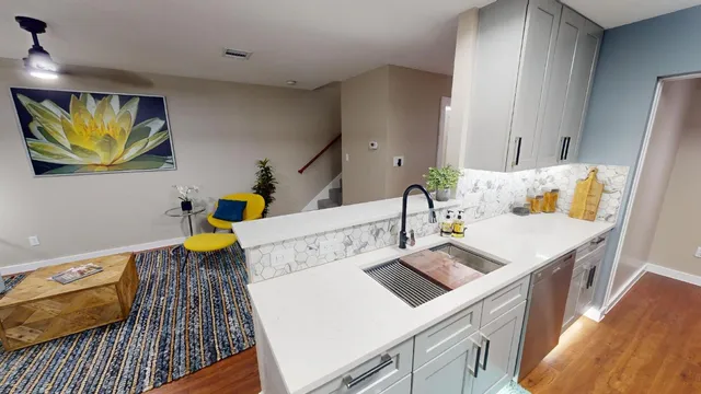 a living room with furniture and wooden floor