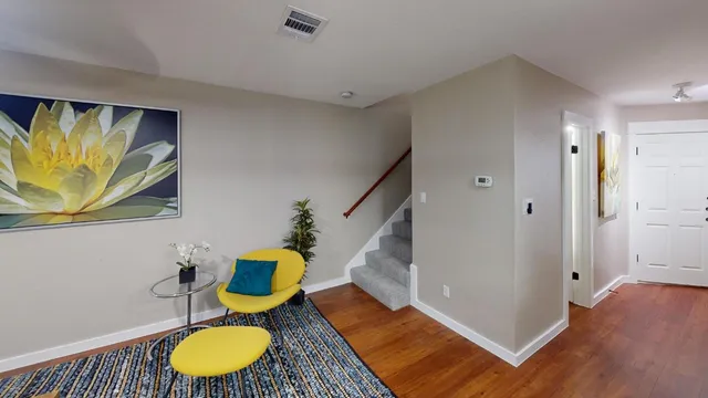 view of a room with wooden floor and white wall