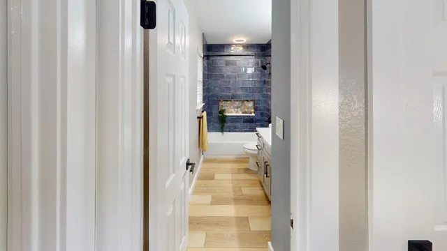 a view of a hallway with wooden floor and staircase