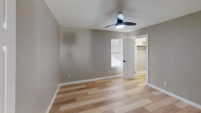 a view of an empty room and wooden floor