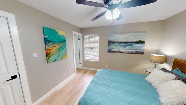 a bedroom with a bed and a lamp