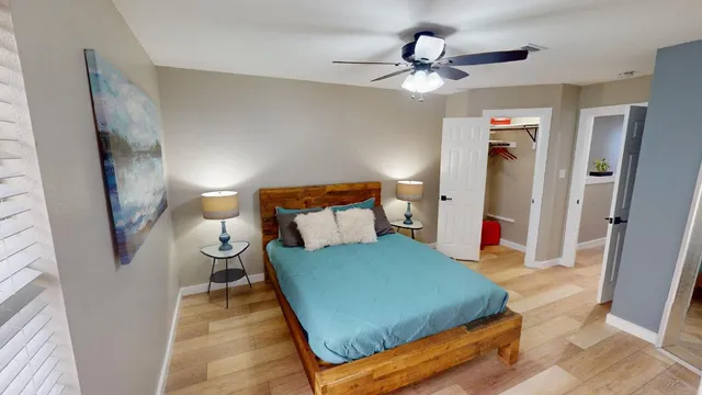 a bedroom with a bed and a painting on the wall