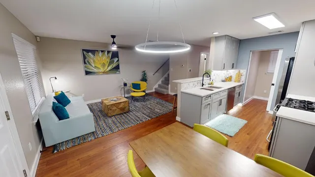 a living room with furniture and wooden floor