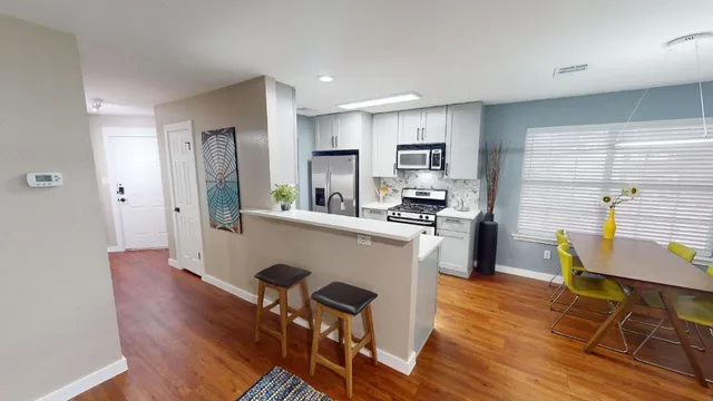 a dining room with furniture and wooden floor