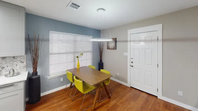a view of a workspace with furniture and wooden floor