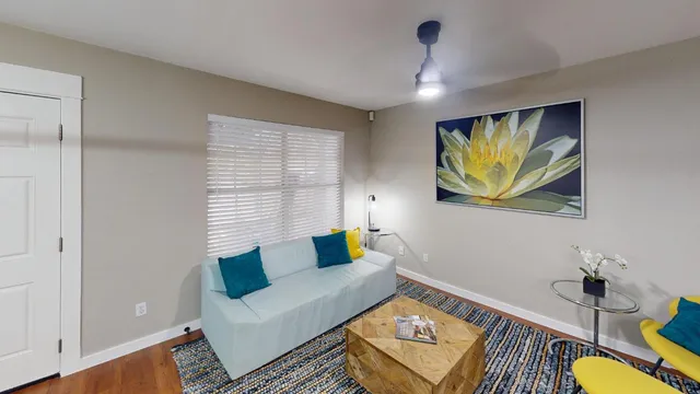 a living room with furniture and wooden floor