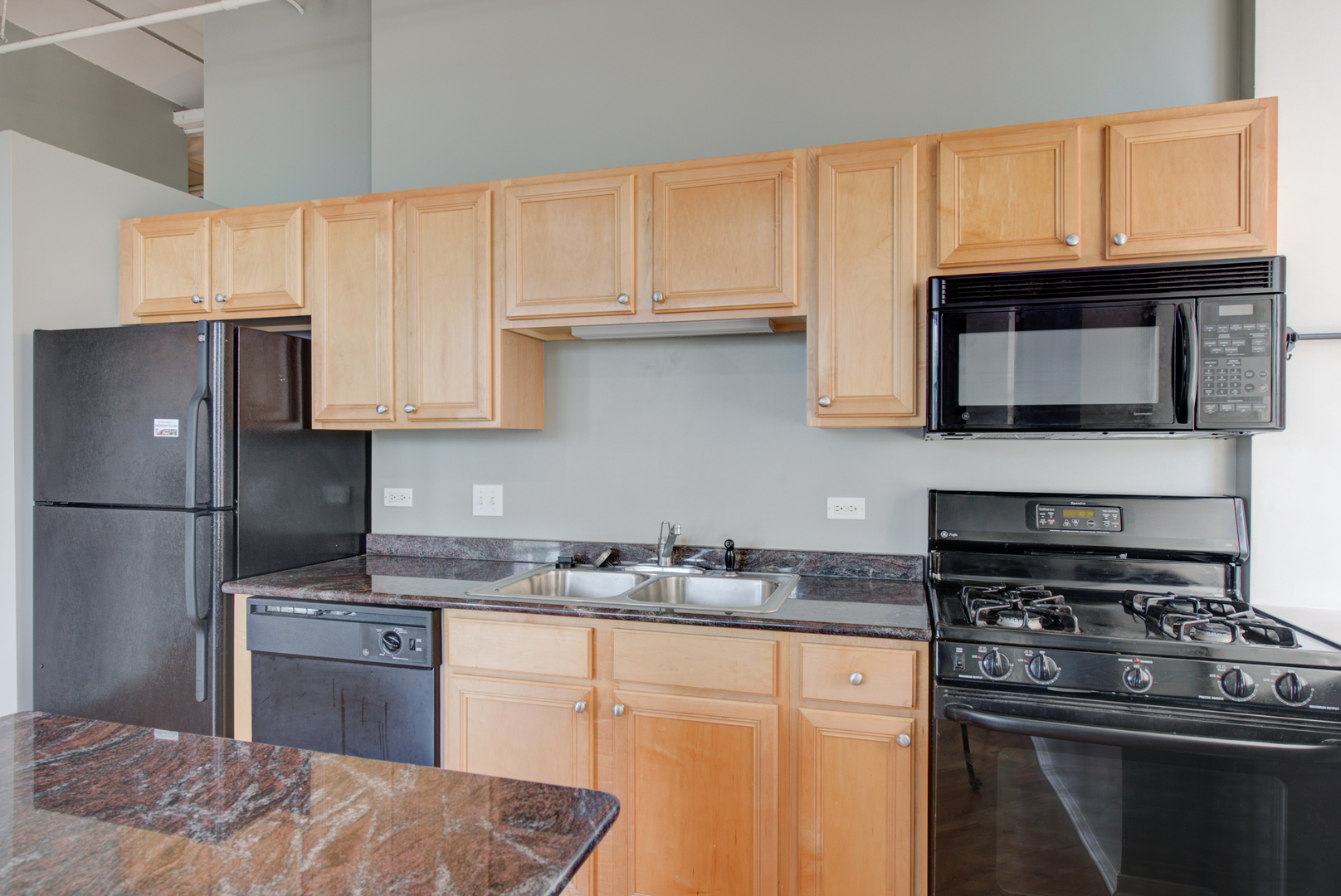 500 South Clinton Street, Unit 230 Chicago, IL 60607 - Photo 11 of 31 a kitchen with granite countertop a sink stove and refrigerator
