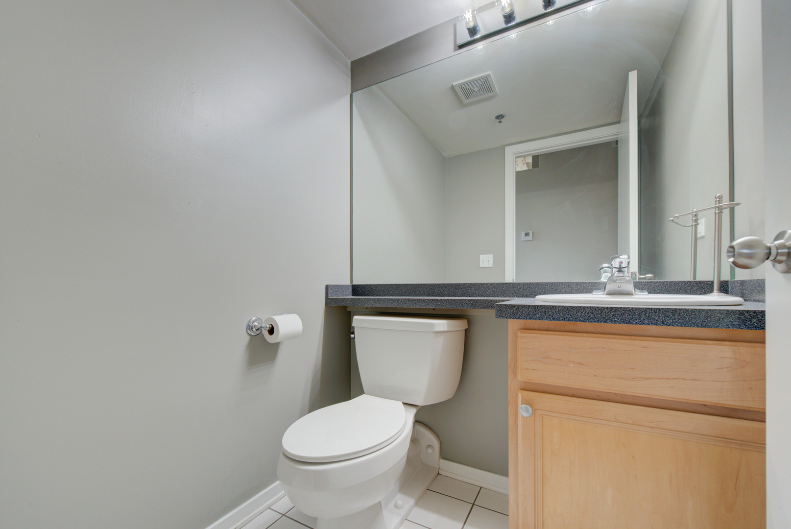 500 South Clinton Street, Unit 230 Chicago, IL 60607 - Photo 14 of 31 a bathroom with a granite countertop toilet and a sink