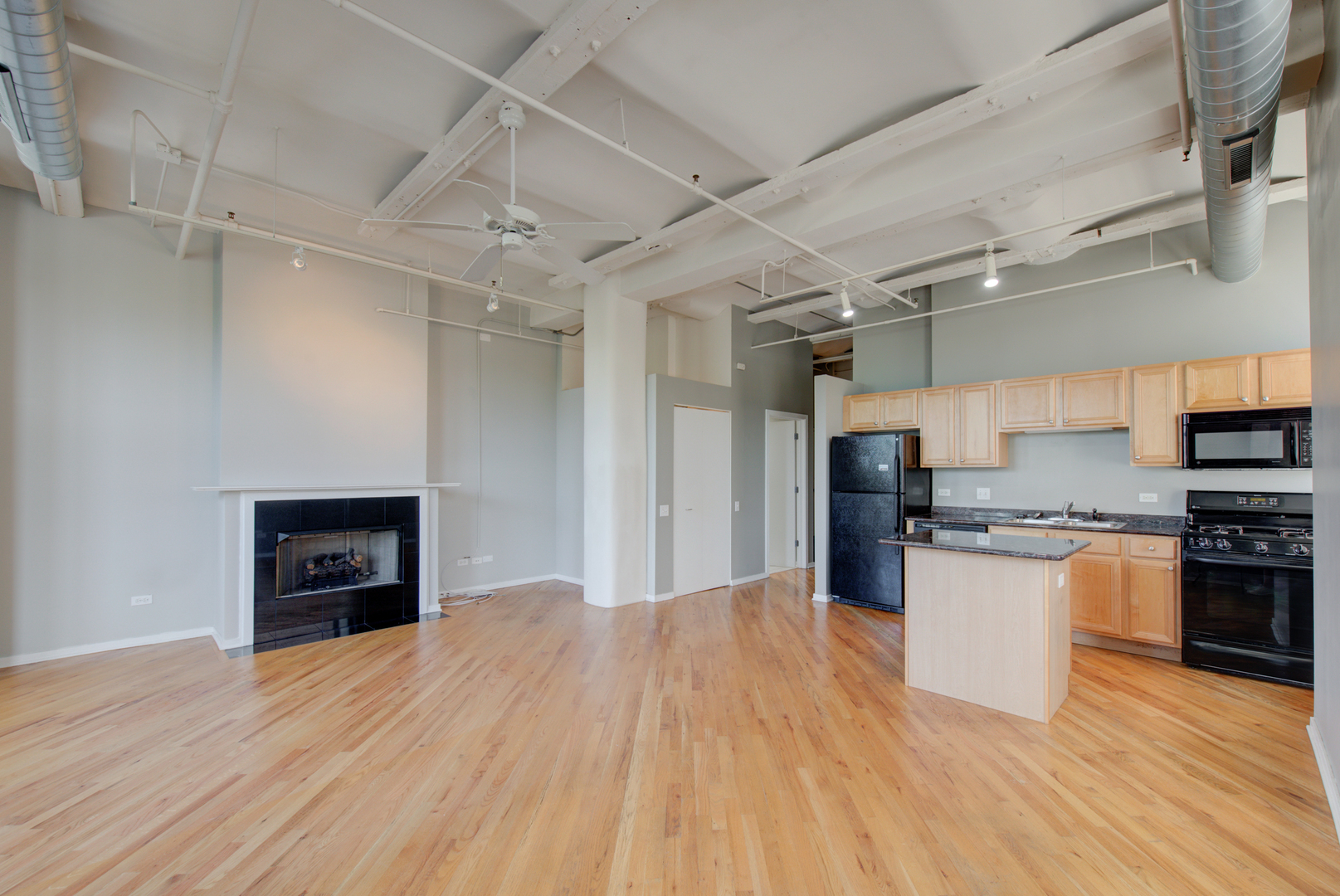 500 South Clinton Street, Unit 230 Chicago, IL 60607 - Photo 5 of 31 a kitchen with stainless steel appliances granite countertop a refrigerator and a stove