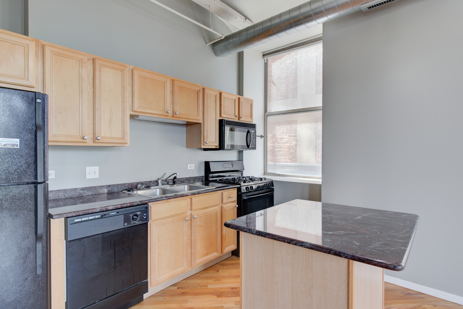 500 South Clinton Street, Unit 230 Chicago, IL 60607 - Photo 9 of 31 a kitchen with granite countertop a sink stove and refrigerator
