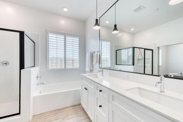 a bathroom with a tub sink and mirror