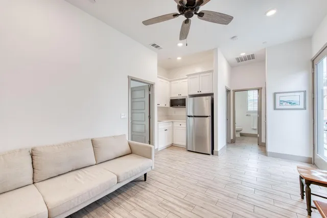 a living room with furniture and kitchen view