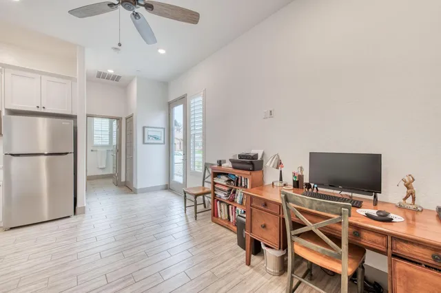 a view of a workspace with furniture and a flat screen tv