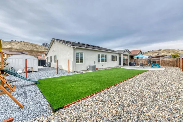 a view of house with a yard
