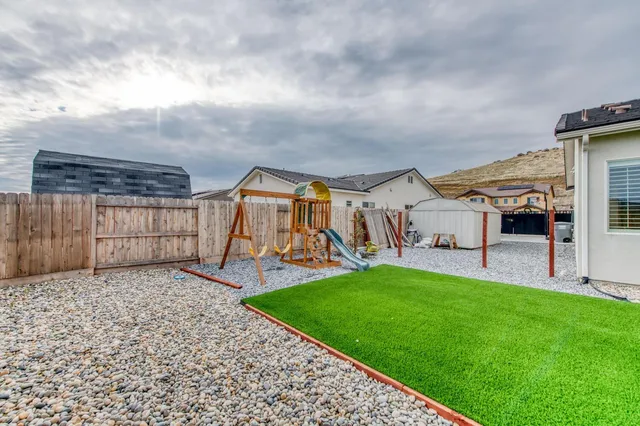 a view of a house with a yard and sitting area