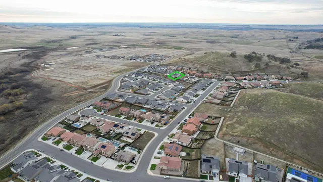 an aerial view of a house with outdoor space and street view