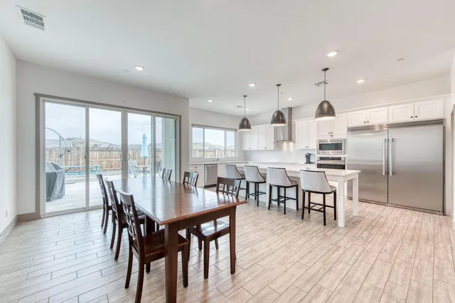 a dining room with furniture window and wooden floor