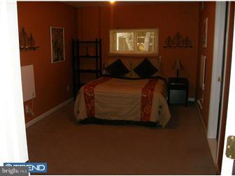 145 Big Oak Road Bridgeton, NJ 08302 - Photo 4 of 12 a bedroom with a bed and a painting on the wall
