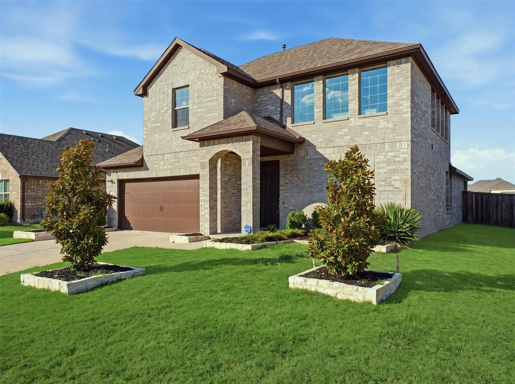 Two-story brick exterior with a prominent arched entry and covered porch
