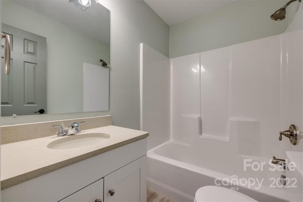 6973 Narrow Lane Road Hickory Grove, SC 29717 - Photo 25 of 35 a bathroom with a granite countertop sink a toilet and shower