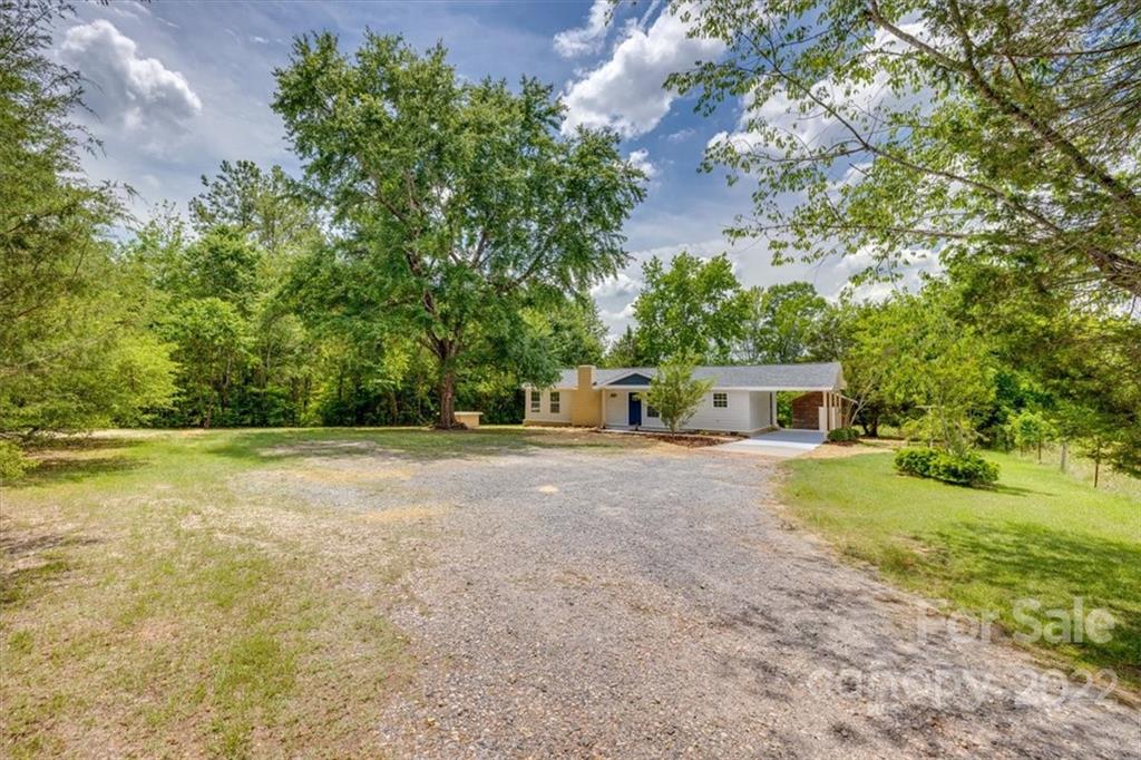 6973 Narrow Lane Road Hickory Grove, SC 29717 - Photo 34 of 35 a view of a house with backyard and trees