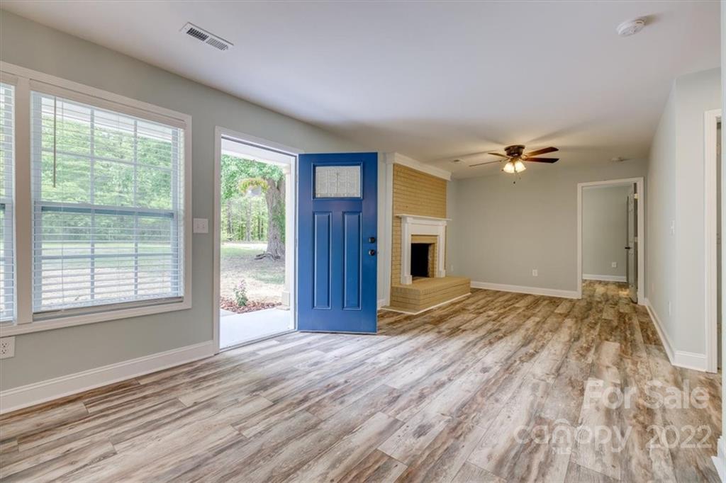 6973 Narrow Lane Road Hickory Grove, SC 29717 - Photo 4 of 35 a view of empty room with wooden floor and fan