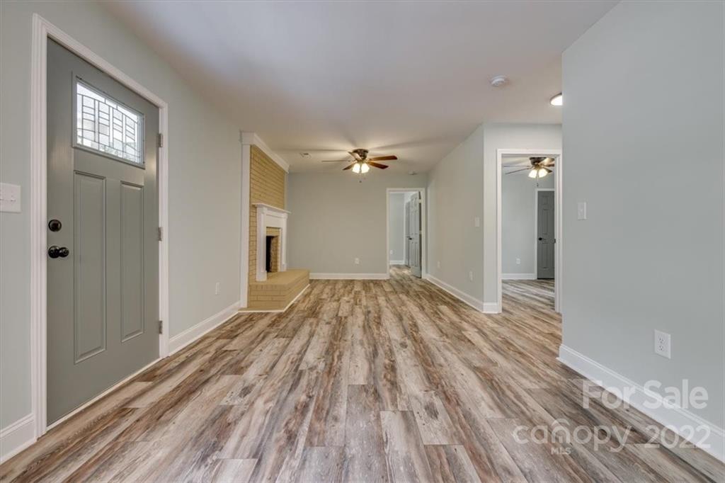 6973 Narrow Lane Road Hickory Grove, SC 29717 - Photo 5 of 35 a view of a room with wooden floor and a ceiling fan