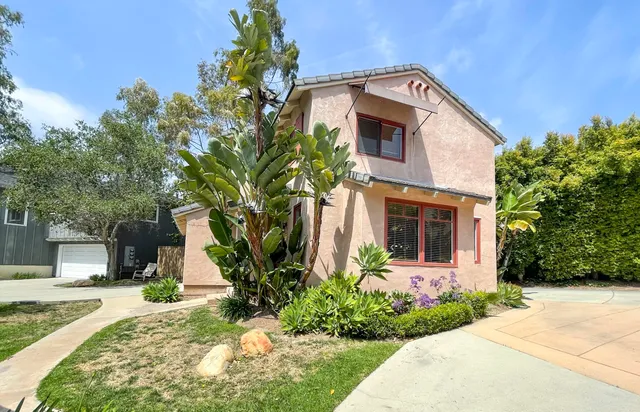 a front view of a house with a yard and a garage