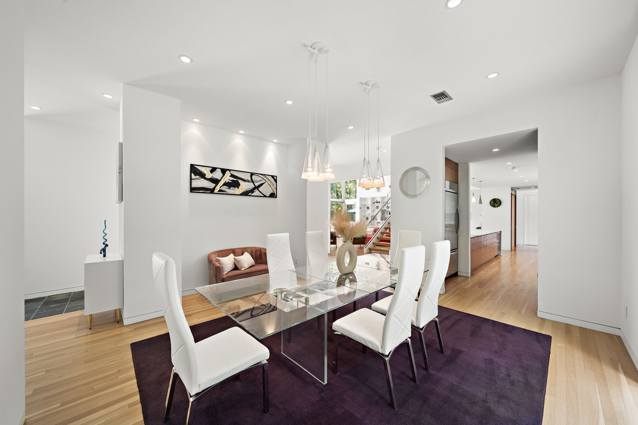 118 Angel Leaf Road The Woodlands, TX 77380 - Photo 14 of 50 Another view of the stylish dining area showcasing large picture windows with lush green views and a seamless connection to surrounding living spaces.