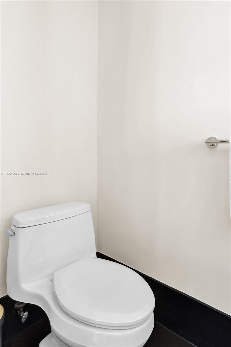 101 20th Street, Unit 1805 Miami Beach, FL 33139 - Photo 14 of 50 a white toilet sitting next to a white wall